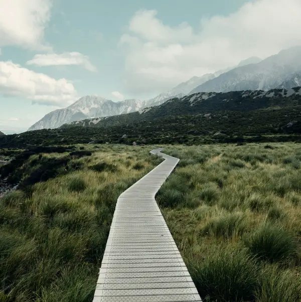 Zigzagging path leading up to a mountain in a grassland